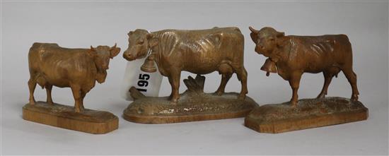 Three Bavarian carved boxwood models of cows with bells